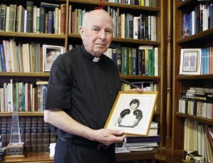 Bishop Daly with a portrait of Jackie Duddy the young man shot dead on Bloody Sunday