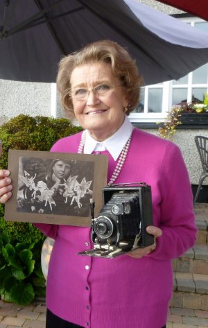 Christine Lynch with Conal Doyle's camera and the picture of her mother with the Cottingly fairies.