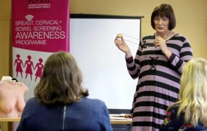 Anne McGale, facilitator from the Women’s Resource and Development Agency, demonstrates how to look for abnormal breast lumps Picture by Mal McCann Irish News